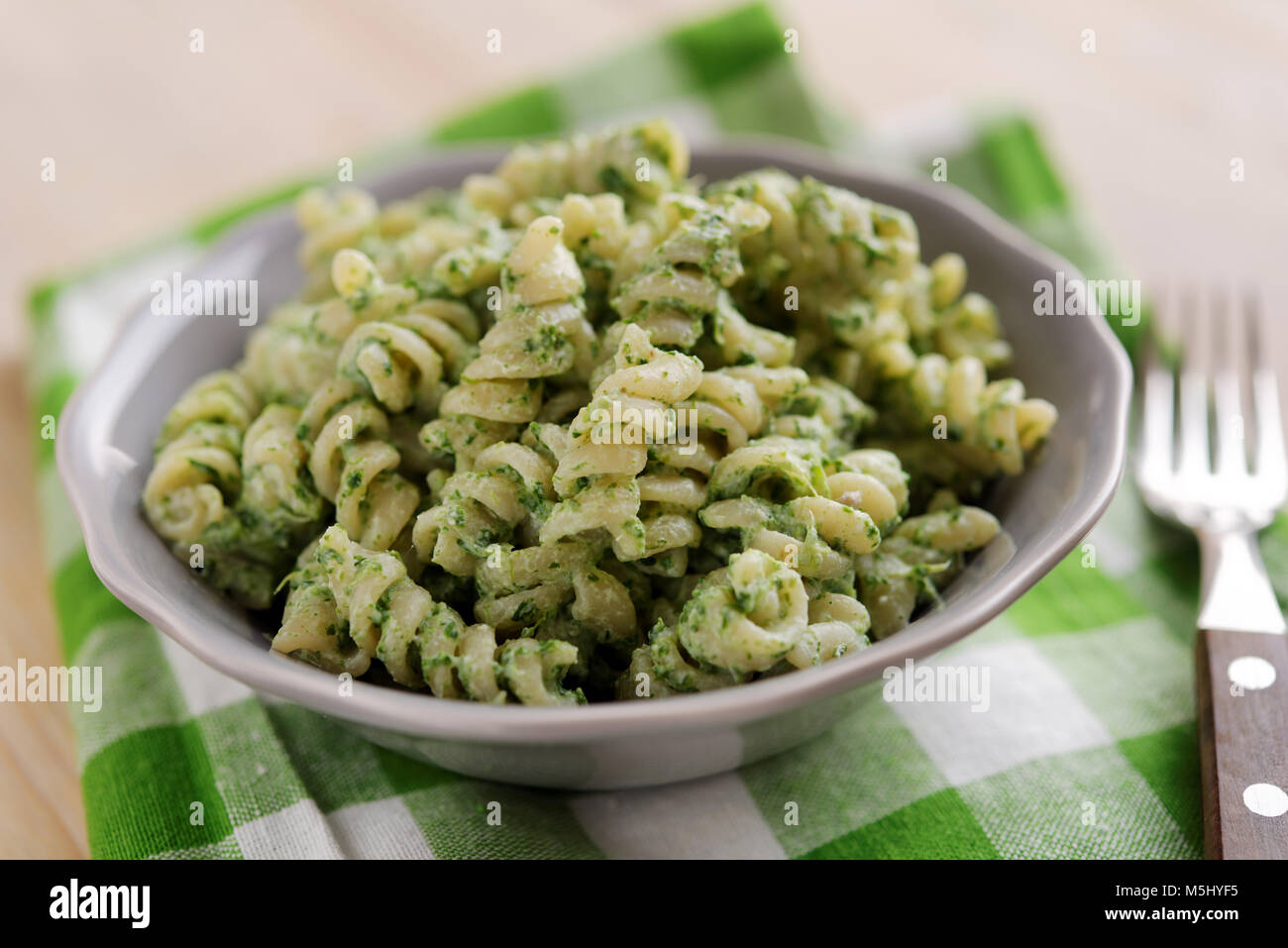 Fusilli pasta with spinach and ricotta cheese in a bowl Stock Photo