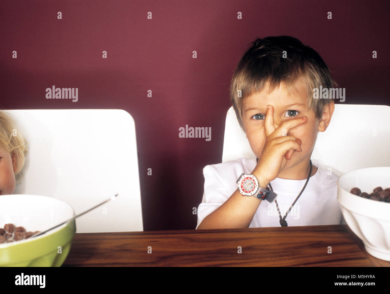 Portrait of little boy at breakfast table Stock Photo