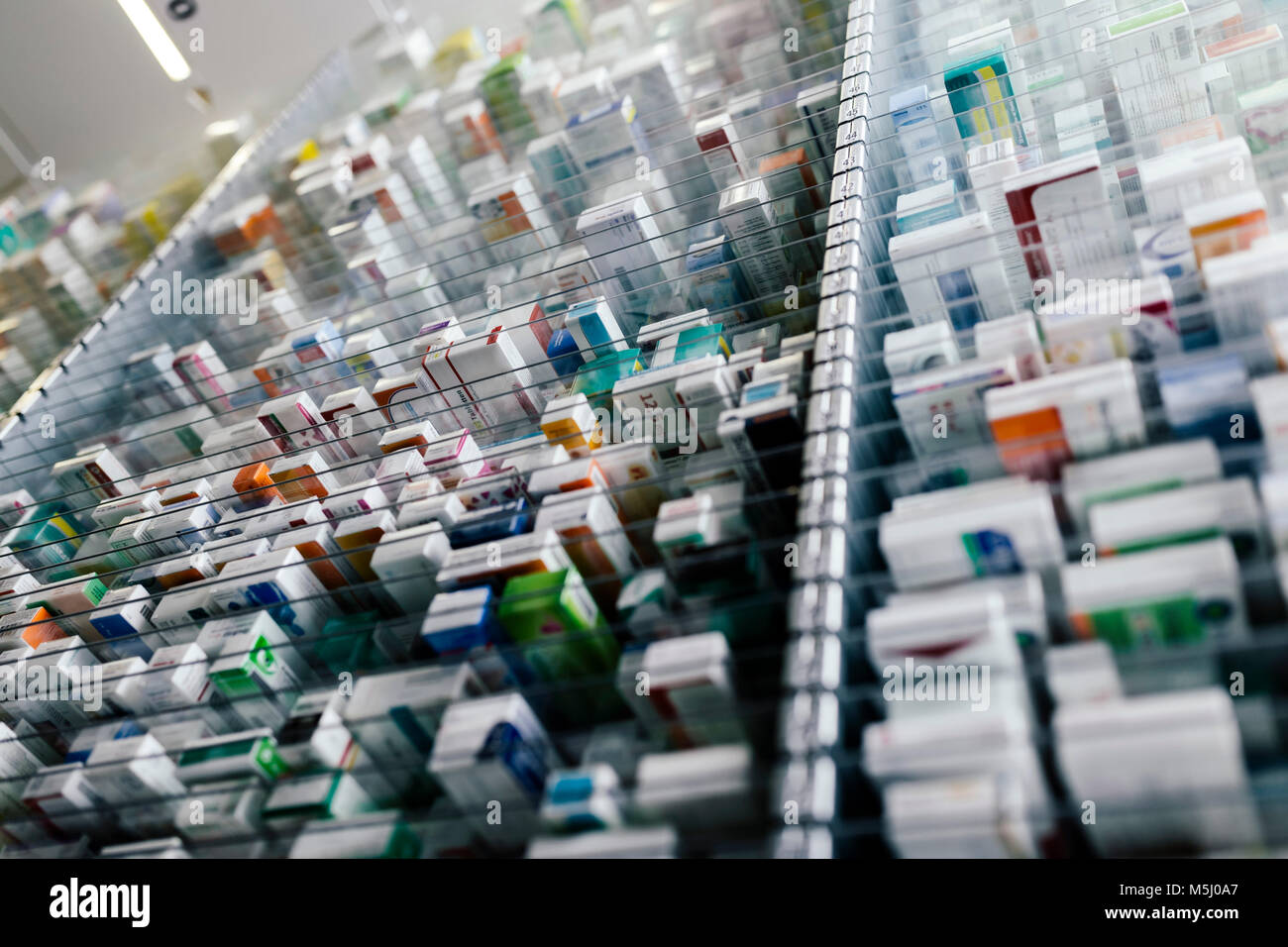 Medicine in shelves in commissioning machine in pharmacy Stock Photo