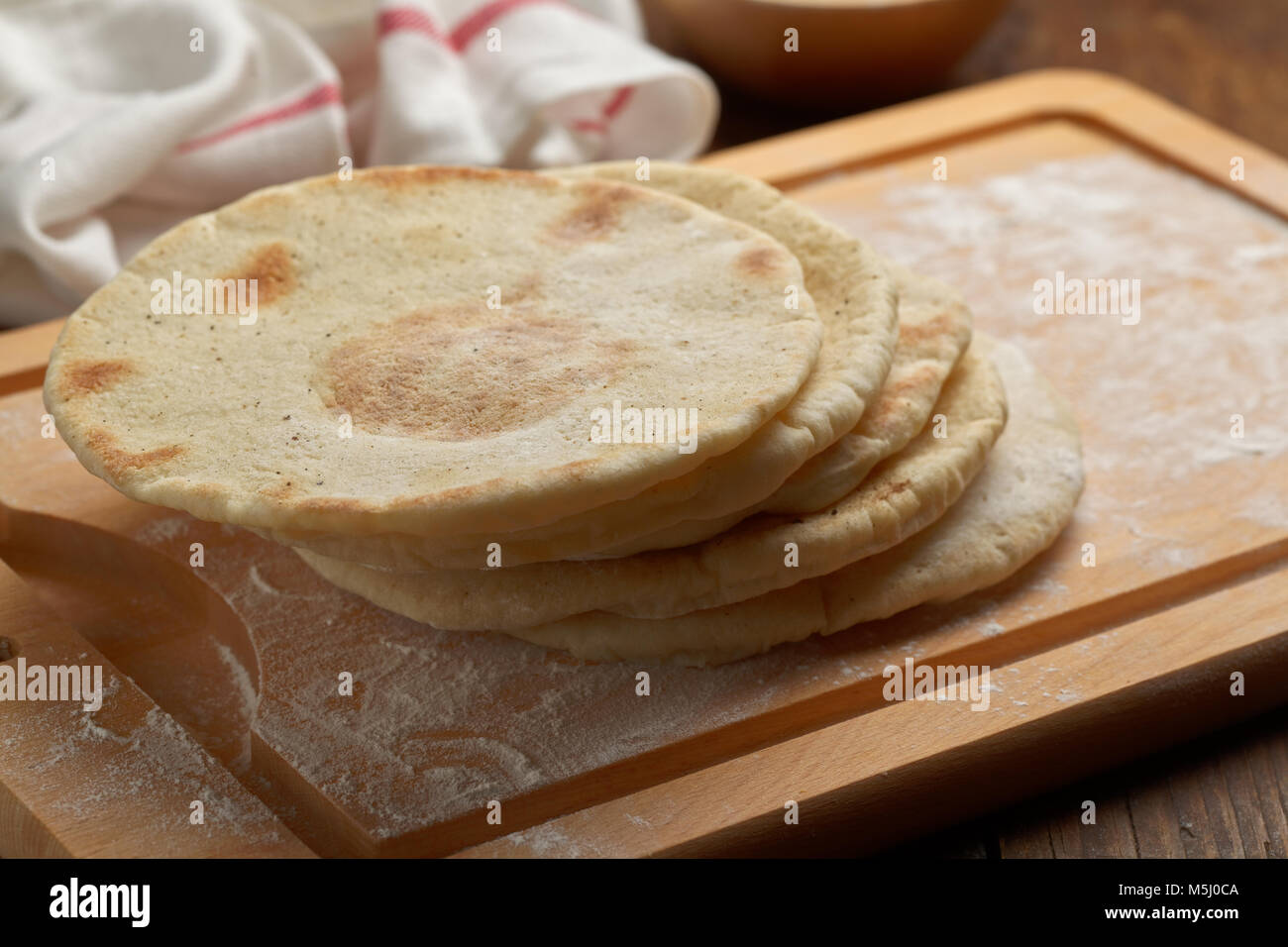Pita breads on a chopping board Stock Photo