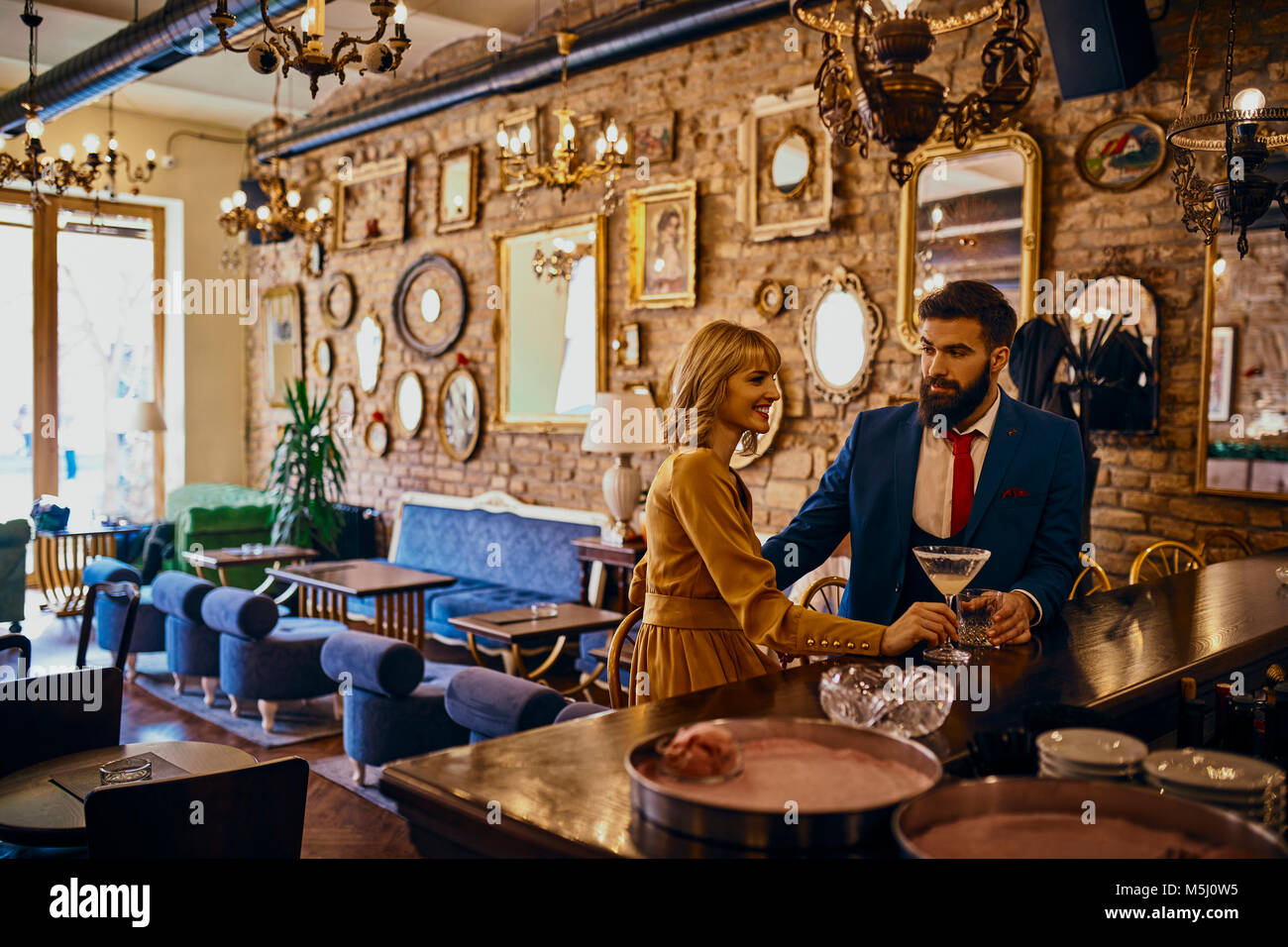 Elegant couple having a drink in a bar Stock Photo