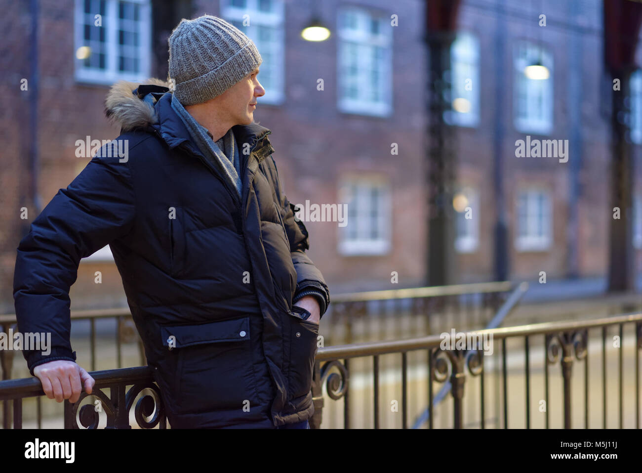 Mature man in winter clothes standing at the entrance to metro station in Copenhagen, Denmark Stock Photo