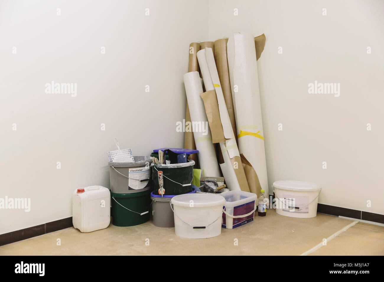 Materials for painting and wallpapering in corner of a room Stock Photo