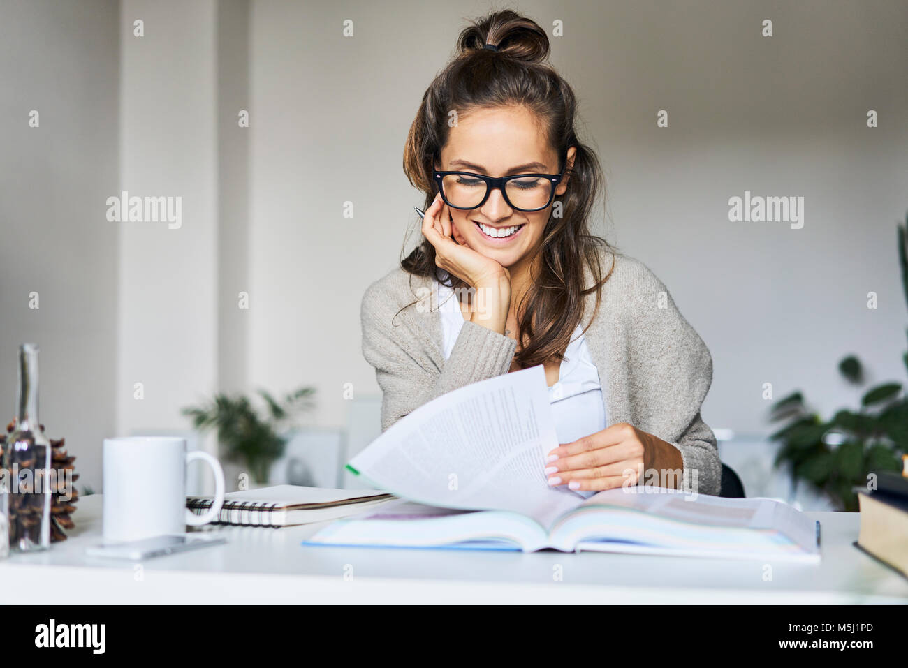 Happy female student learning at home Stock Photo