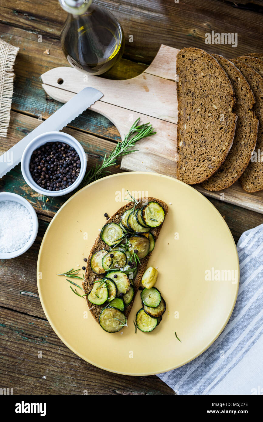 Bruschetta and various ingredients, rye bread, zucchini, rosemary