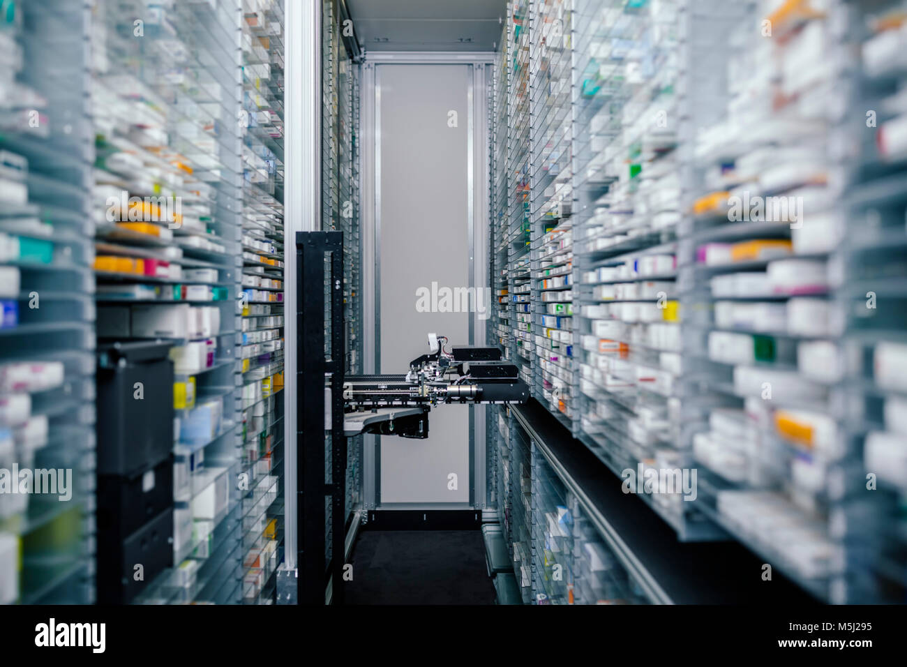 Medicine in shelves in commissioning machine in pharmacy Stock Photo
