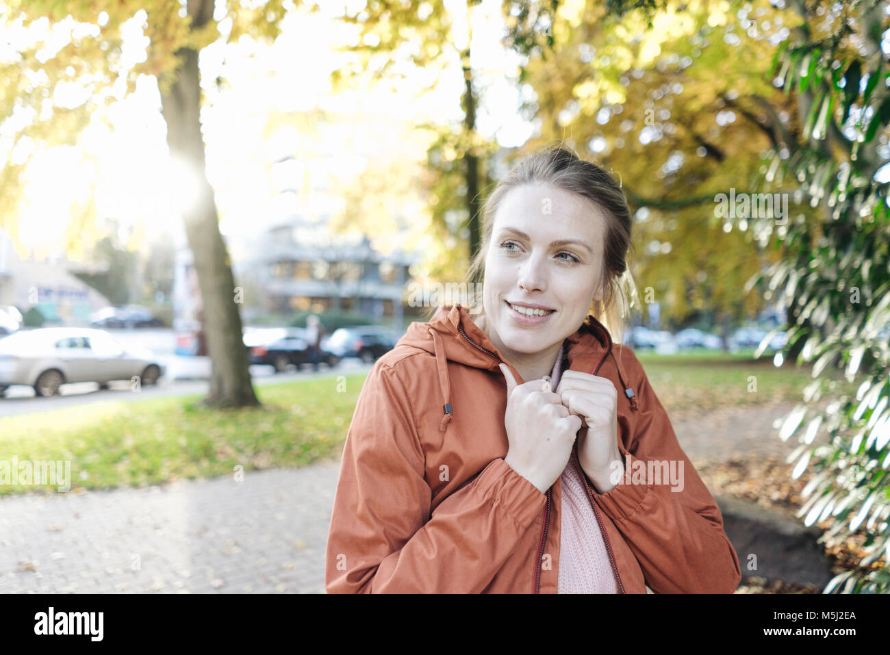 Portrait of young woman in autumnal park Stock Photo - Alamy