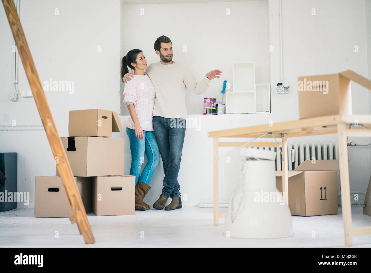Couple moving into new home making plans Stock Photo - Alamy