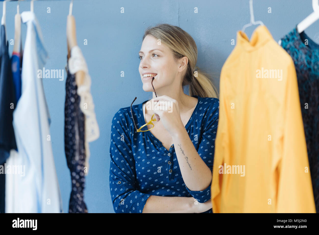 Portrait of happy fashion designer in her studio Stock Photo - Alamy