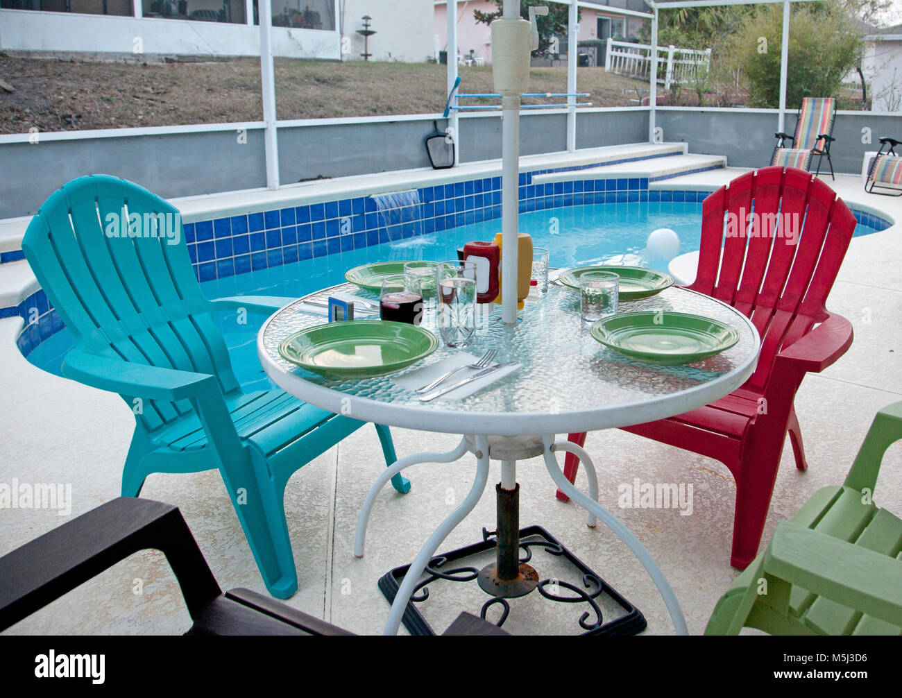 Table And Patio Chairs Set Up To Eat Outside By The Pool