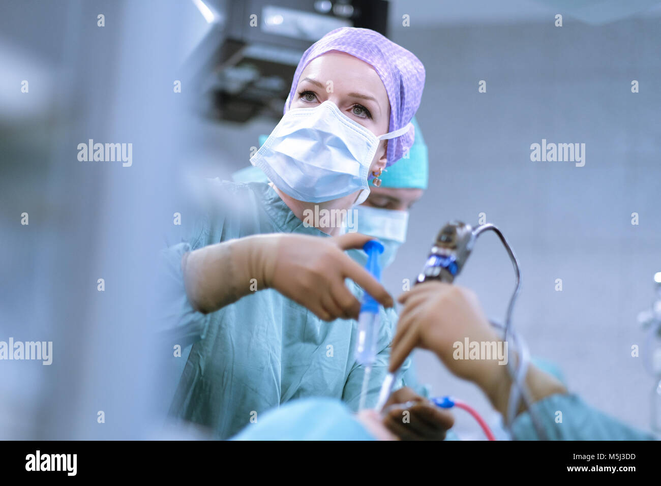 Neurosurgeon in scrubs during an operation Stock Photo