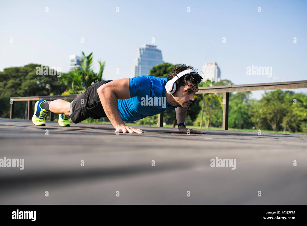 Athlete exercising push-ups in the city Stock Photo - Alamy