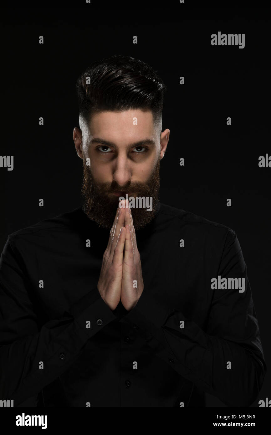 Portrait of a young man, folding his hands Stock Photo