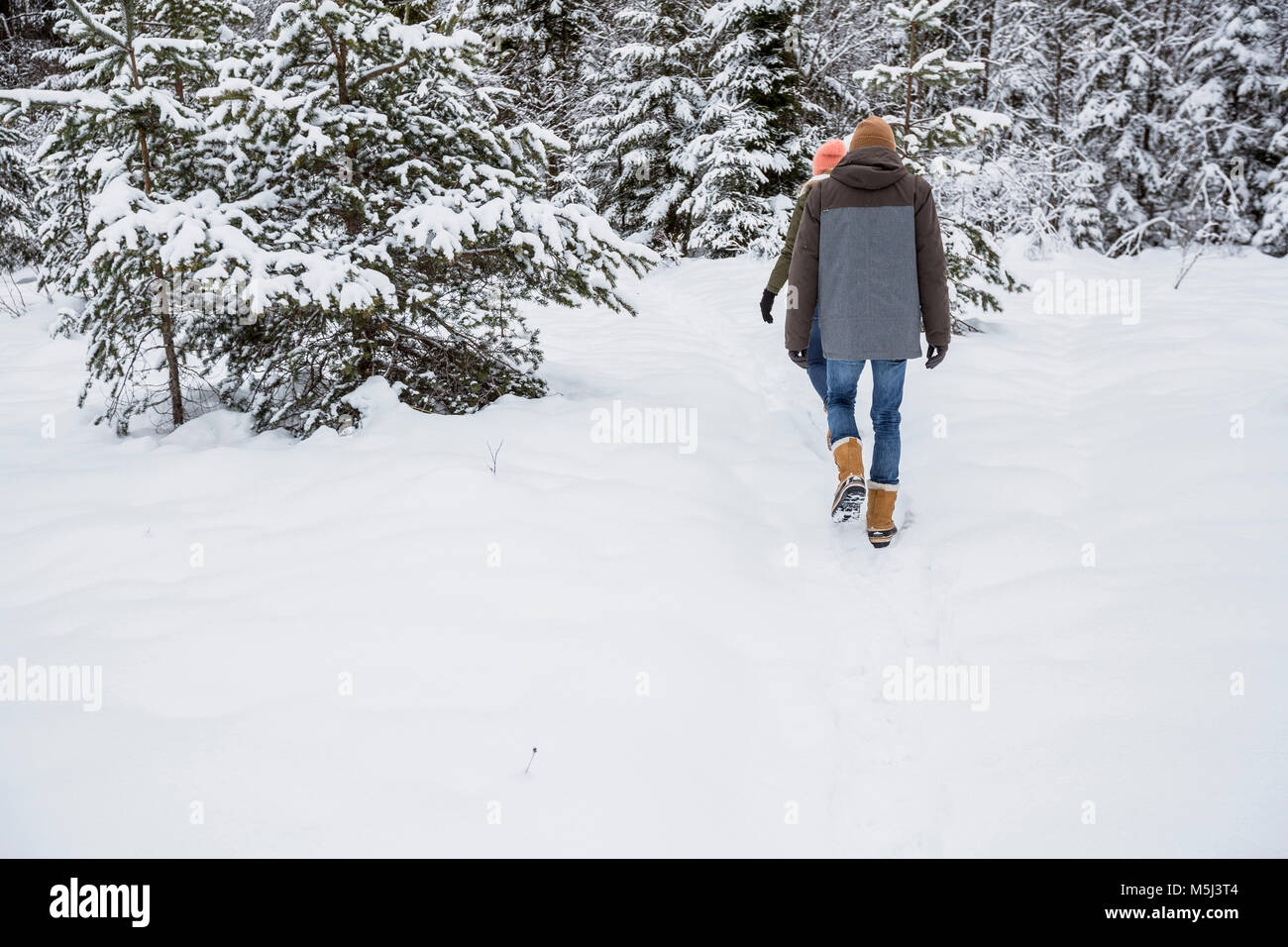 Couple walk snow rear view hi-res stock photography and images - Alamy