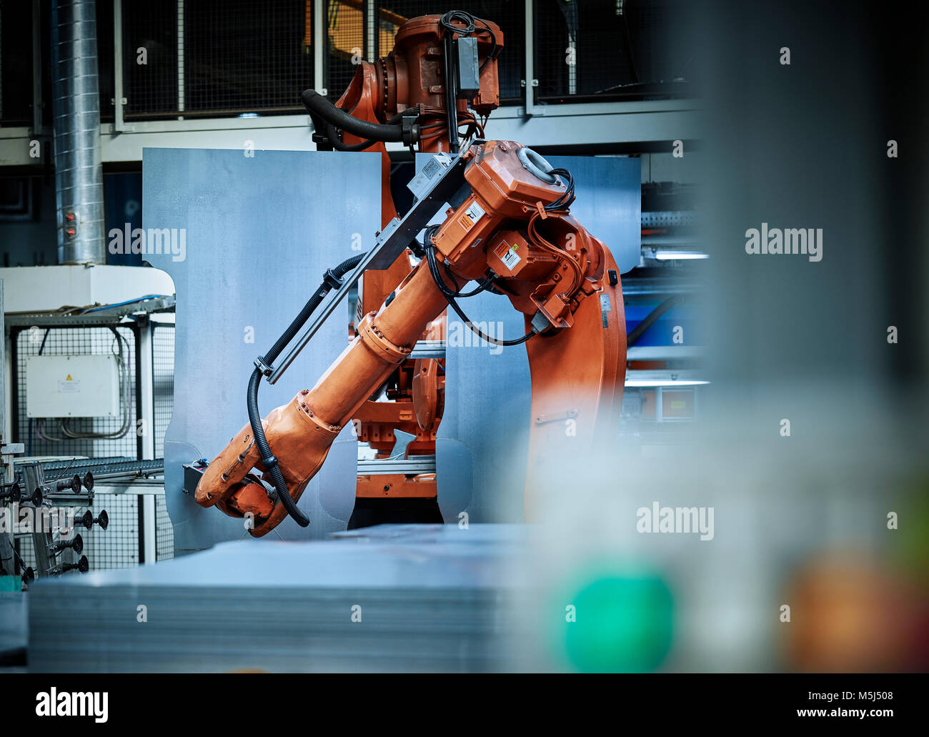 Industrial robot arm used in metalworking Stock Photo