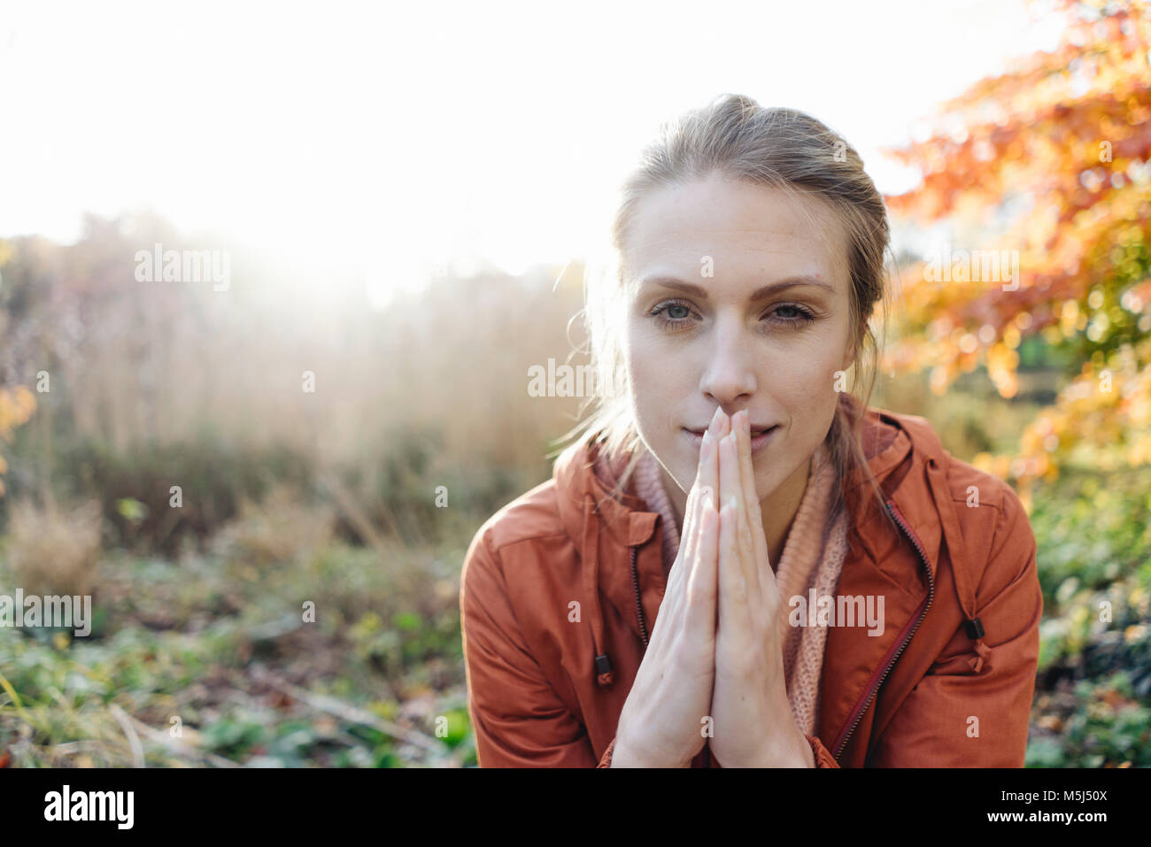 Portrait of young woman in autumnal park Stock Photo