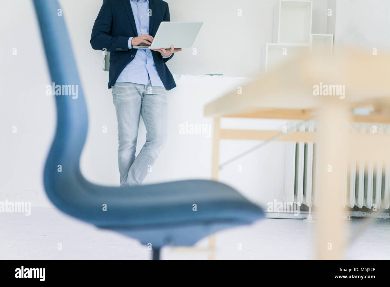 Low section of businessman using laptop in office Stock Photo