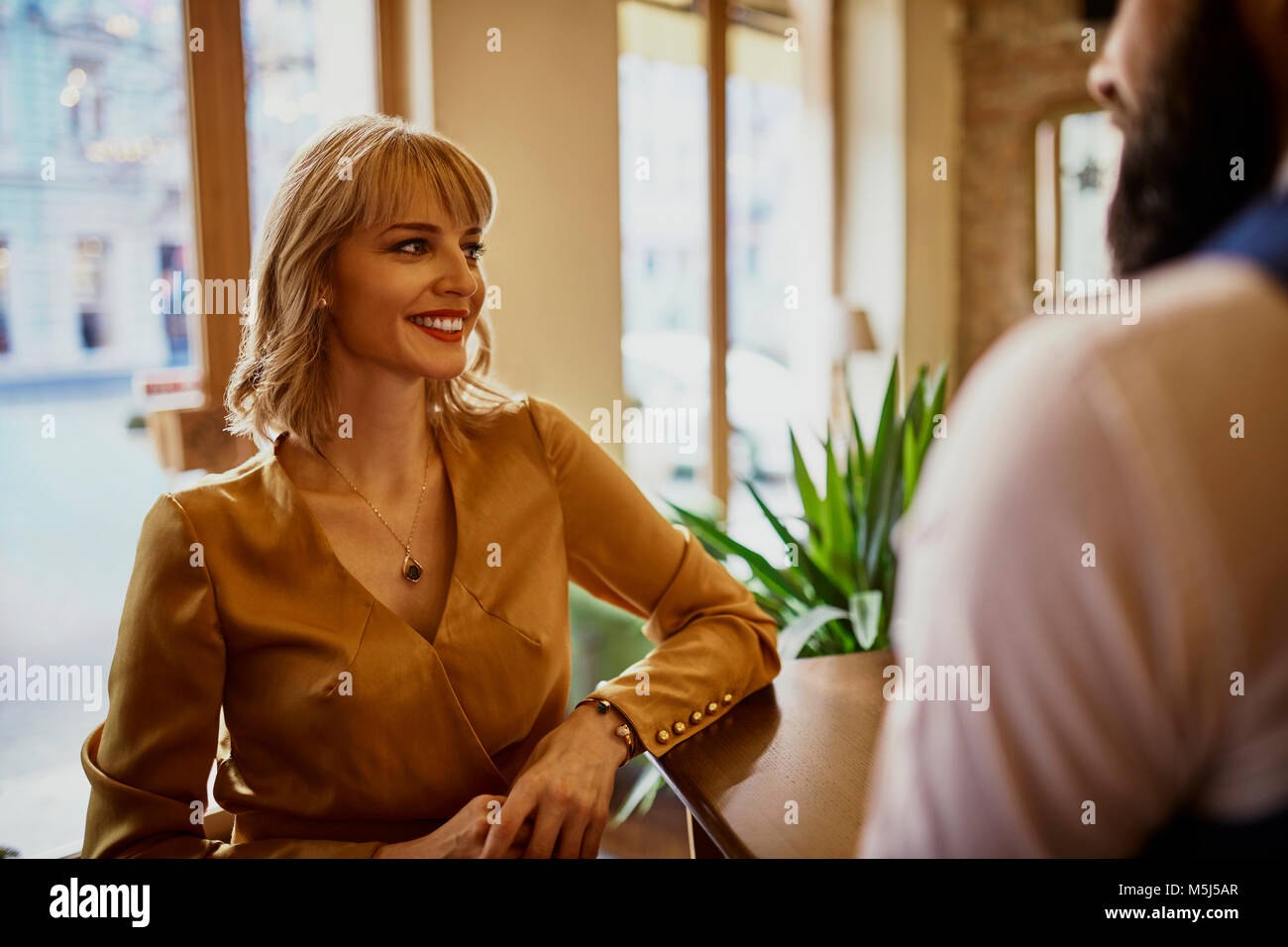 Elegant smiling woman with man in a bar Stock Photo