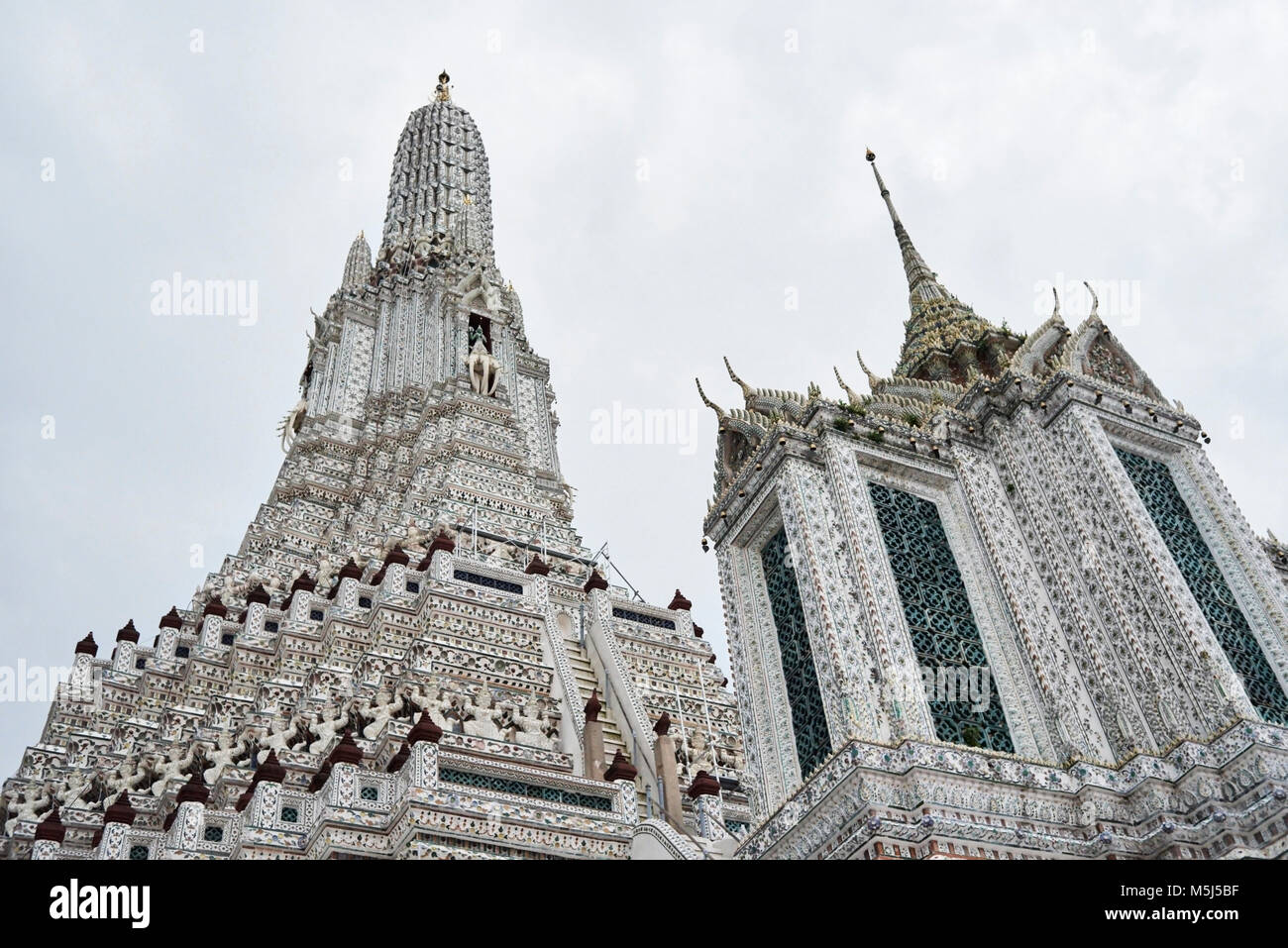 Wat Arun buddhist temple view in a cloudy day. Bangkok, Thailand. Stock Photo