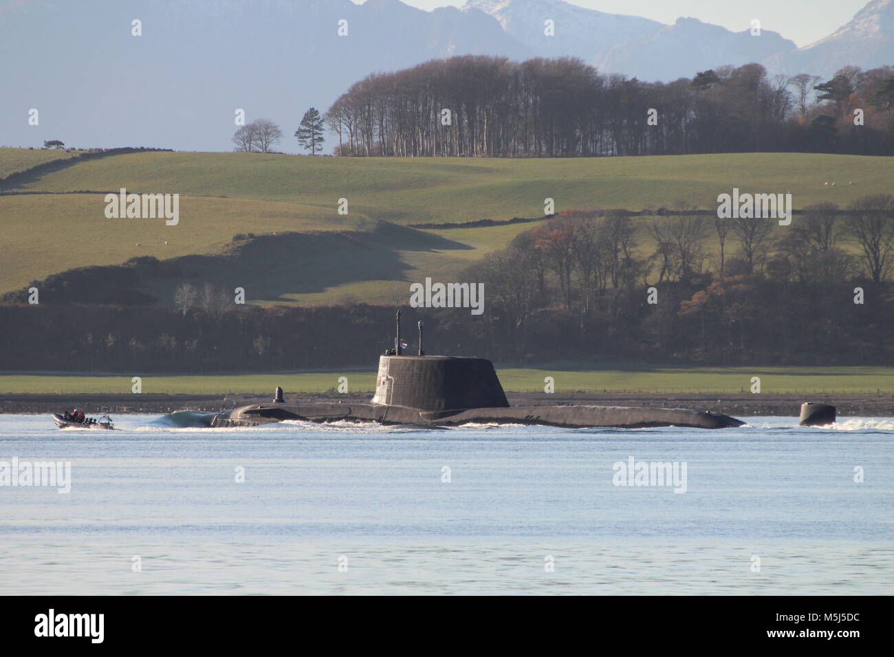 An Astute-class submarine operated by the Royal Navy, is seen passing through the Largs Channel in the Firth of Clyde, with an MoD Police escort. Stock Photo