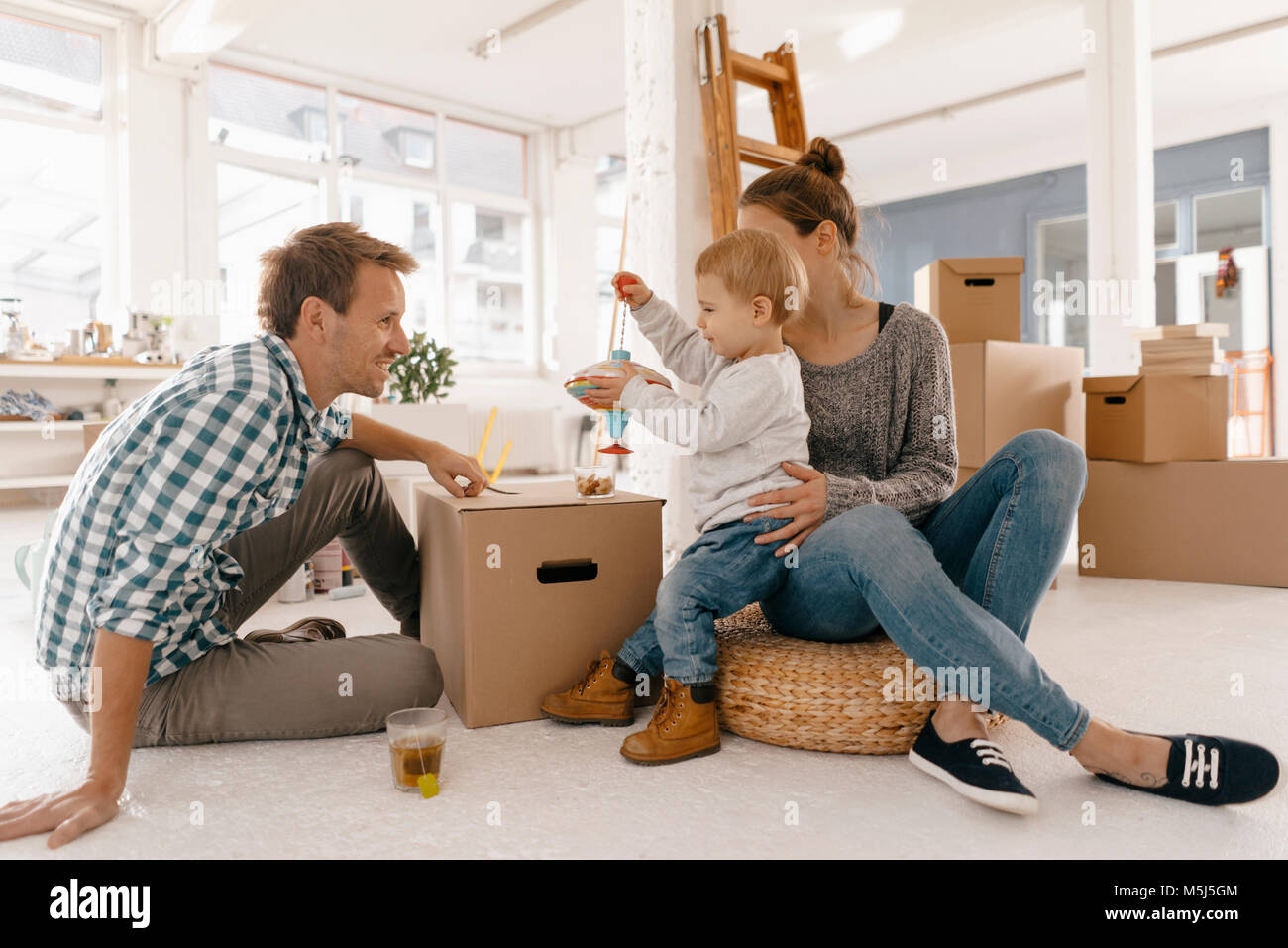 Happy family moving into new home Stock Photo