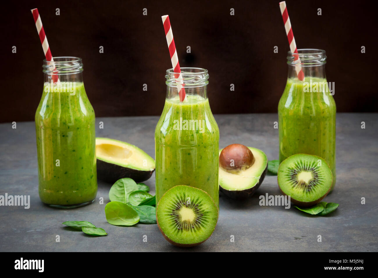 Green detox smoothie with avocado, kiwi and baby spinach Stock Photo