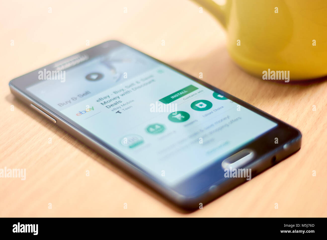 BUENOS AIRES, ARGENTINA - FEBRUARY 22, 2018: Mobile phone on table showing the download section for the eBay mobile app on the Google Play store. Stock Photo