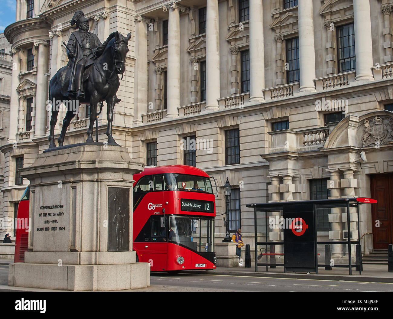 A red double deck bus on Whitehall, London Stock Photo