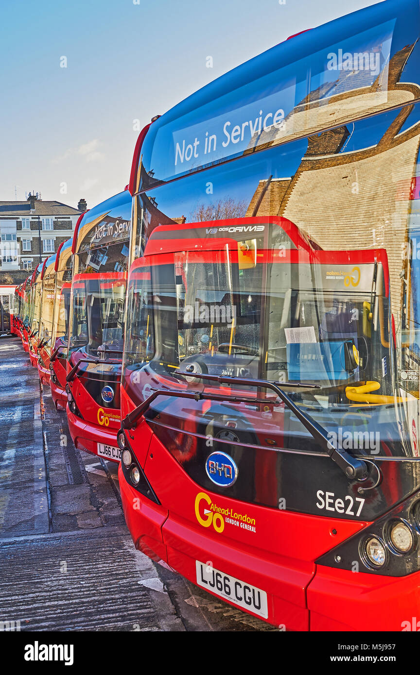 Line of red single deck buses operated by Transport for London standing in the depot close to Waterloo Station in London. Stock Photo