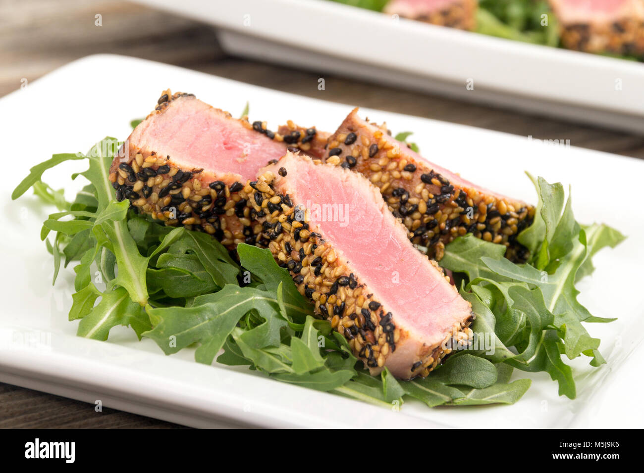 tuna tataki sesame crust appetizer plate over wood backgroung Stock