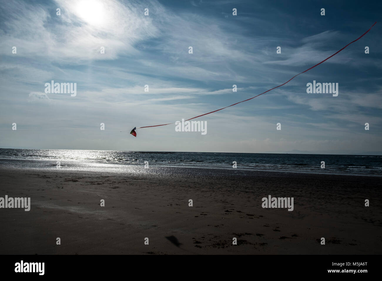 A kite flying over the beach at Seamill in Ayrshire, Scotlands, UK. Stock Photo