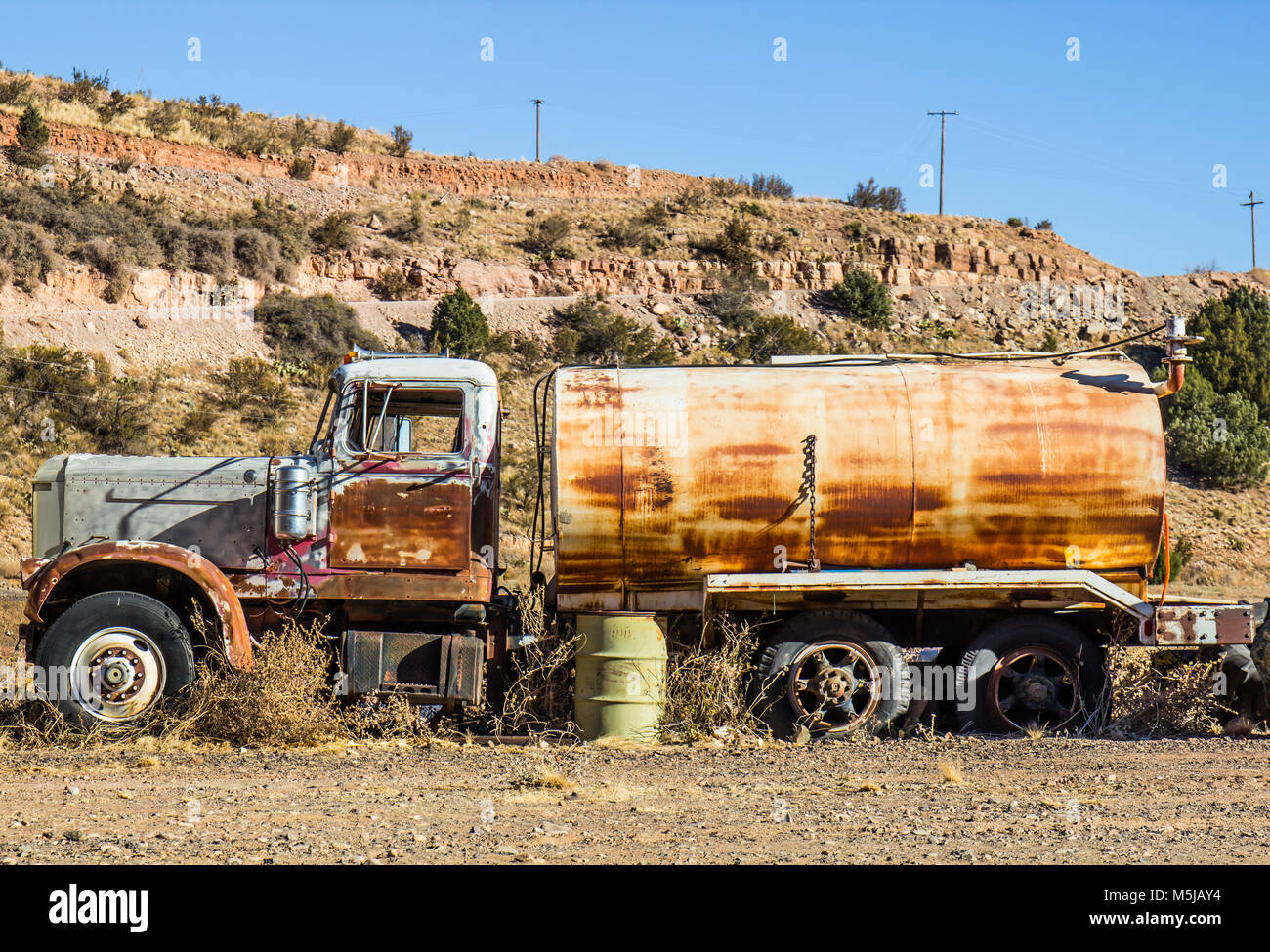 Vintage Rusted Water Tank Truck In Salvage Yard Stock Photo