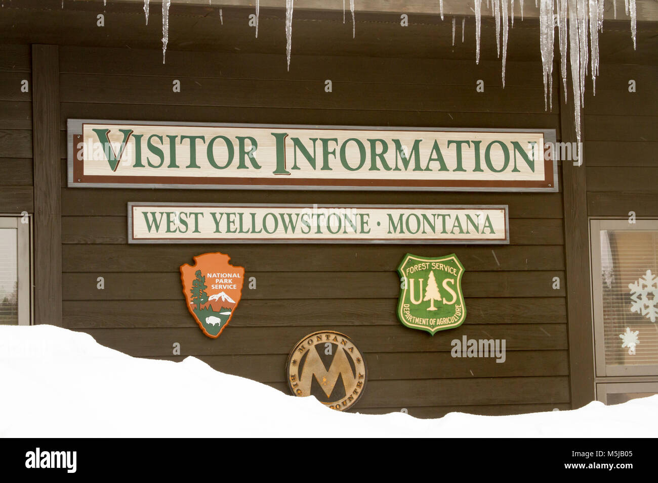 West Yellowstone, Montana, USA - February 8, 2018 :  Visitors Center in West Yellowstone Montana in winter with icicles . Stock Photo