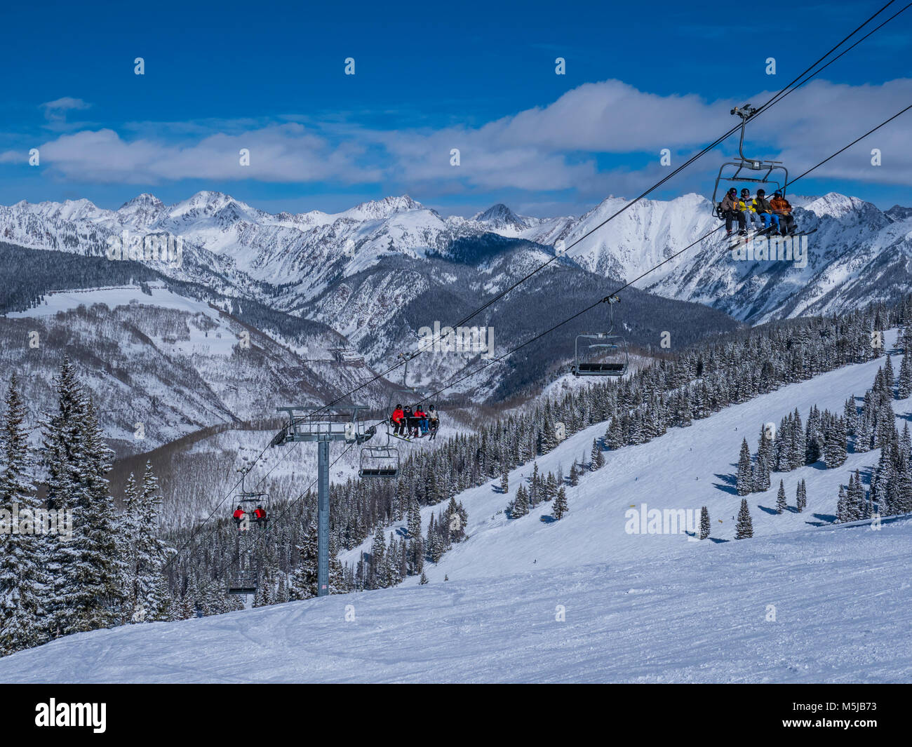 Wildwood Epress Lift 3 with the Gore Range in the background, Hunky Dory ski trail, winter, Vail