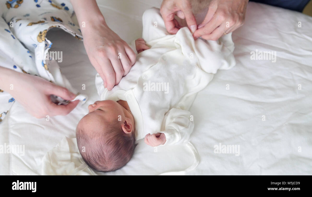Newborn baby, mother and nurse swaddling the infant Stock Photo Alamy