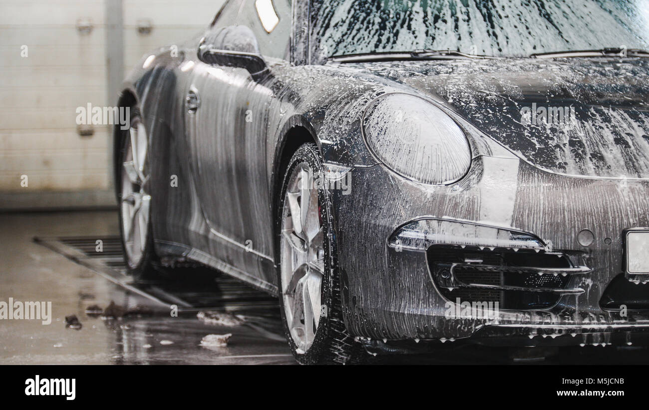 Washing a luxury sport car in the suds Stock Photo Alamy