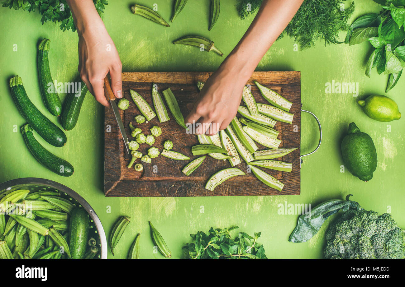 Flatlay of healthy green vegan cooking ingredients on board Stock