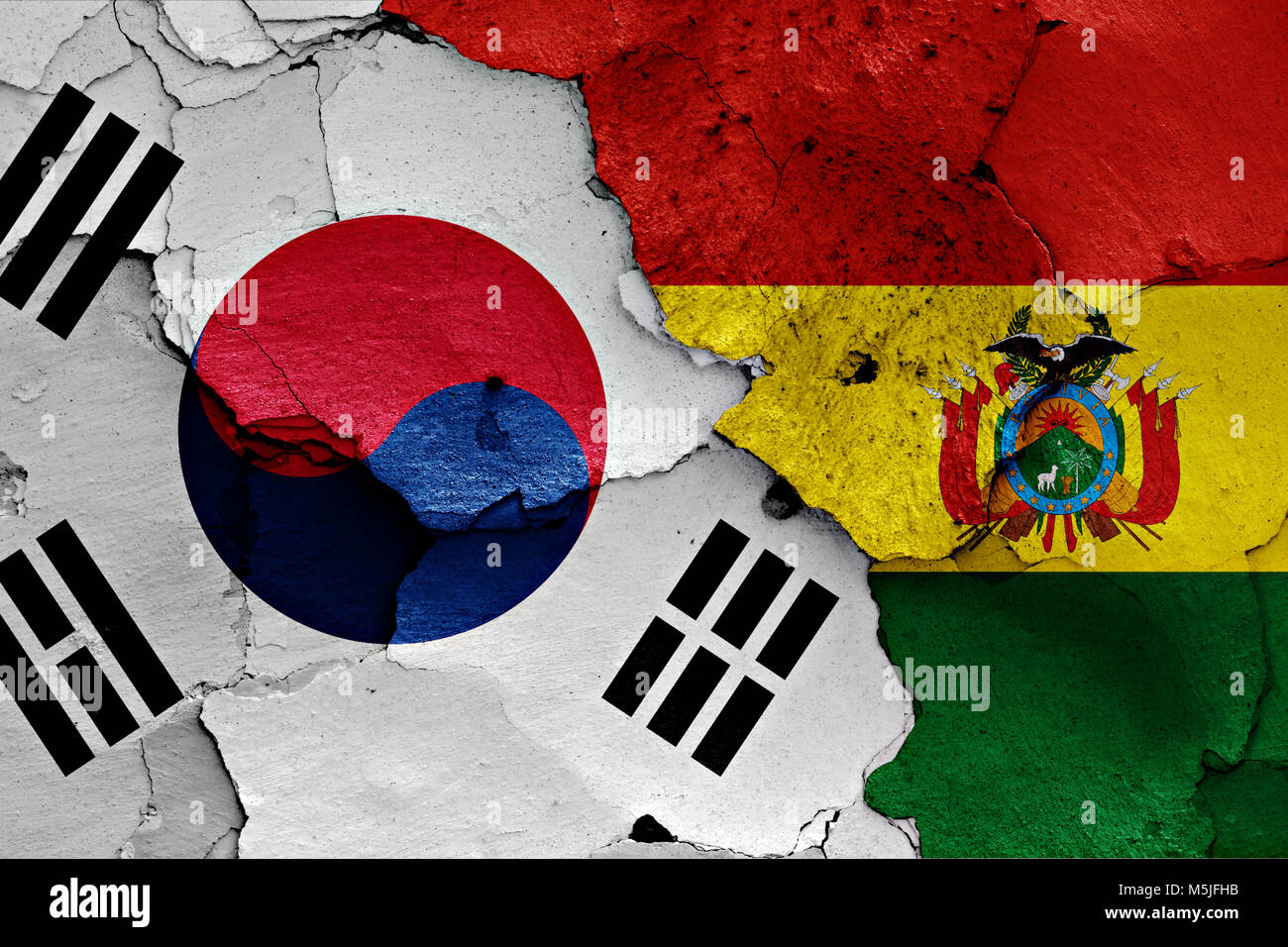 flag of South Korea and Bolivia painted on cracked wall Stock Photo