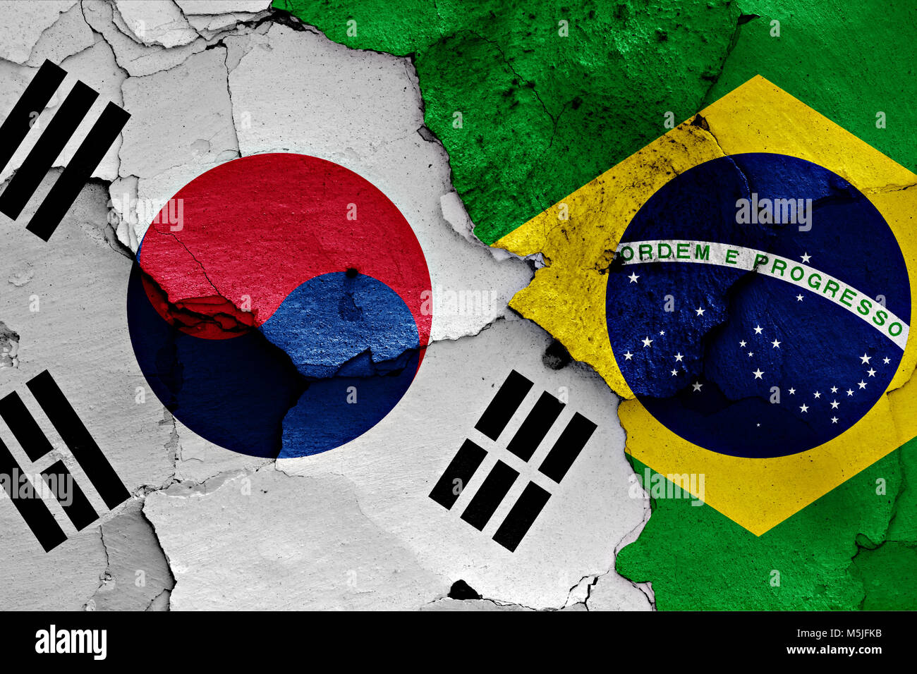 flag of South Korea and Brazil painted on cracked wall Stock Photo