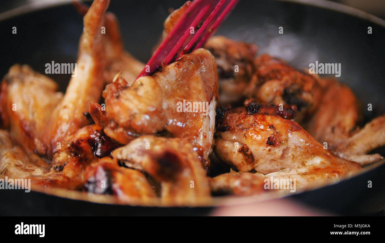 Home junk food Frying Chicken wings preparing in boiling oil Stock