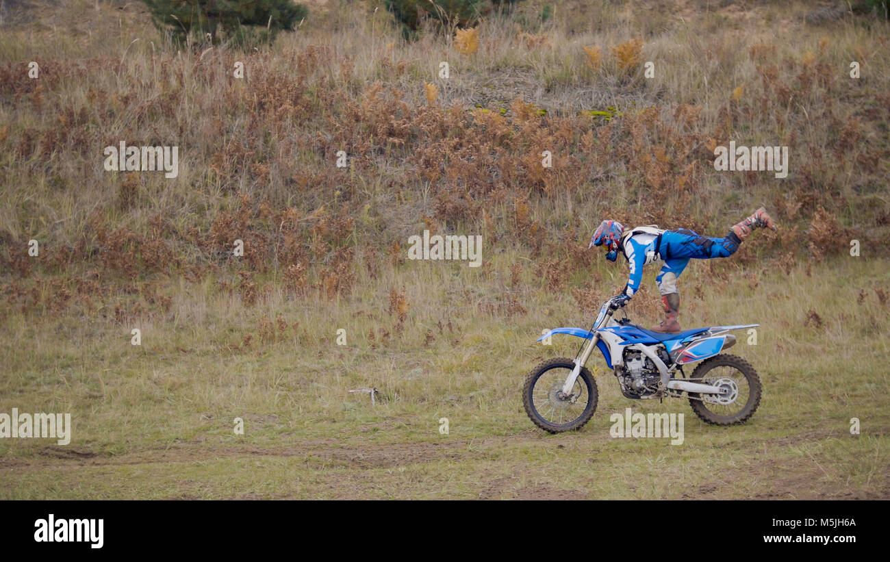 Girl Bike shows acrobatic at MX moto cross racing - rider on a dirt motorcycle Stock Photo