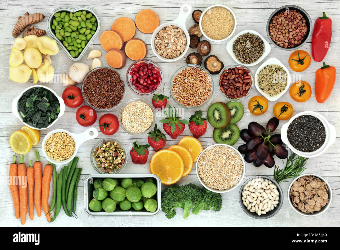 Fresh super food concept with fruit, vegetables, grains, cereals, pulses, seeds, herbs and spice