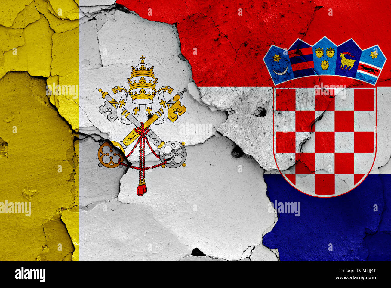 flag of Vatican and Croatia painted on cracked wall Stock Photo