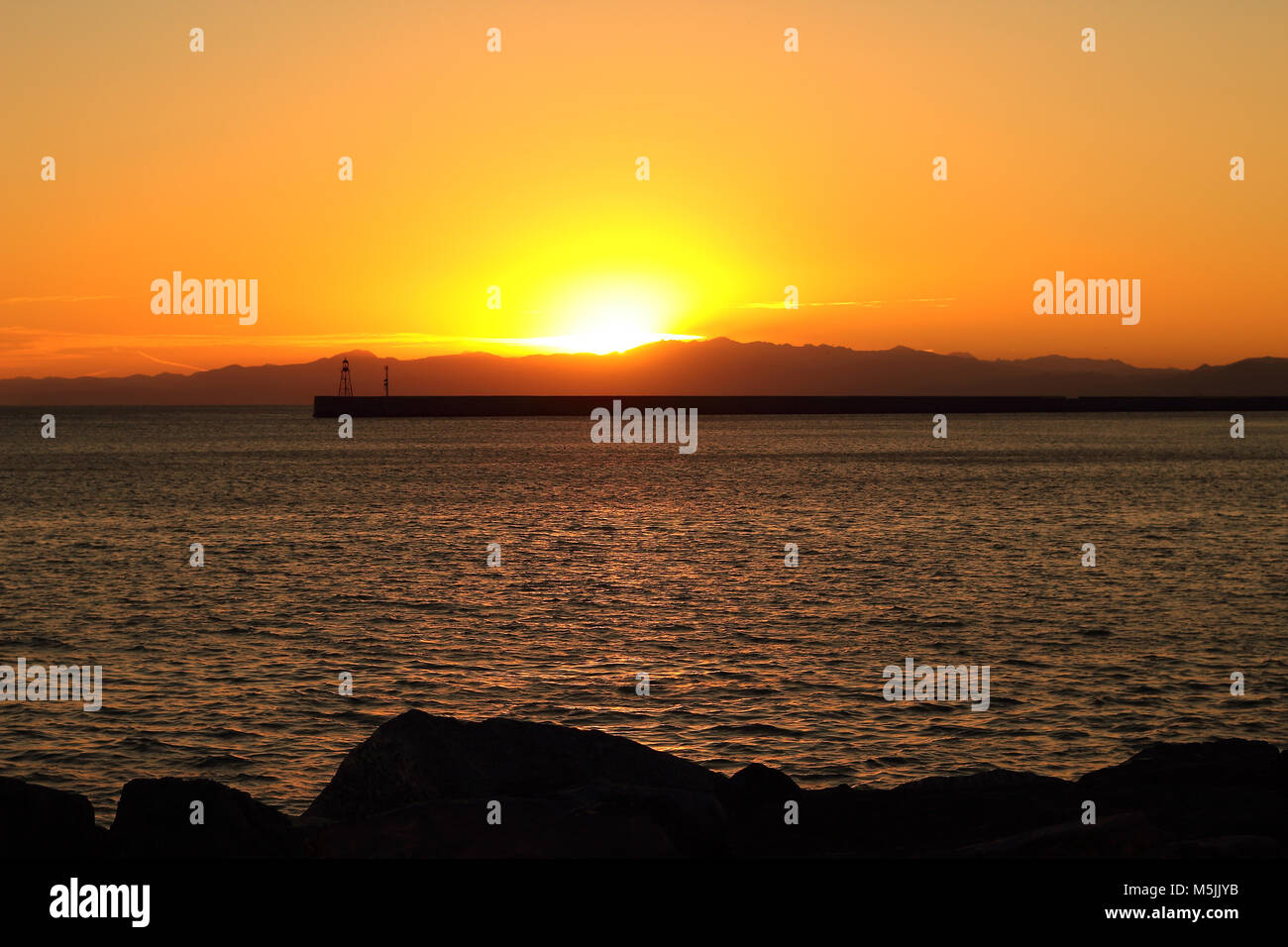 Pier silhouette in sunset background Stock Photo - Alamy