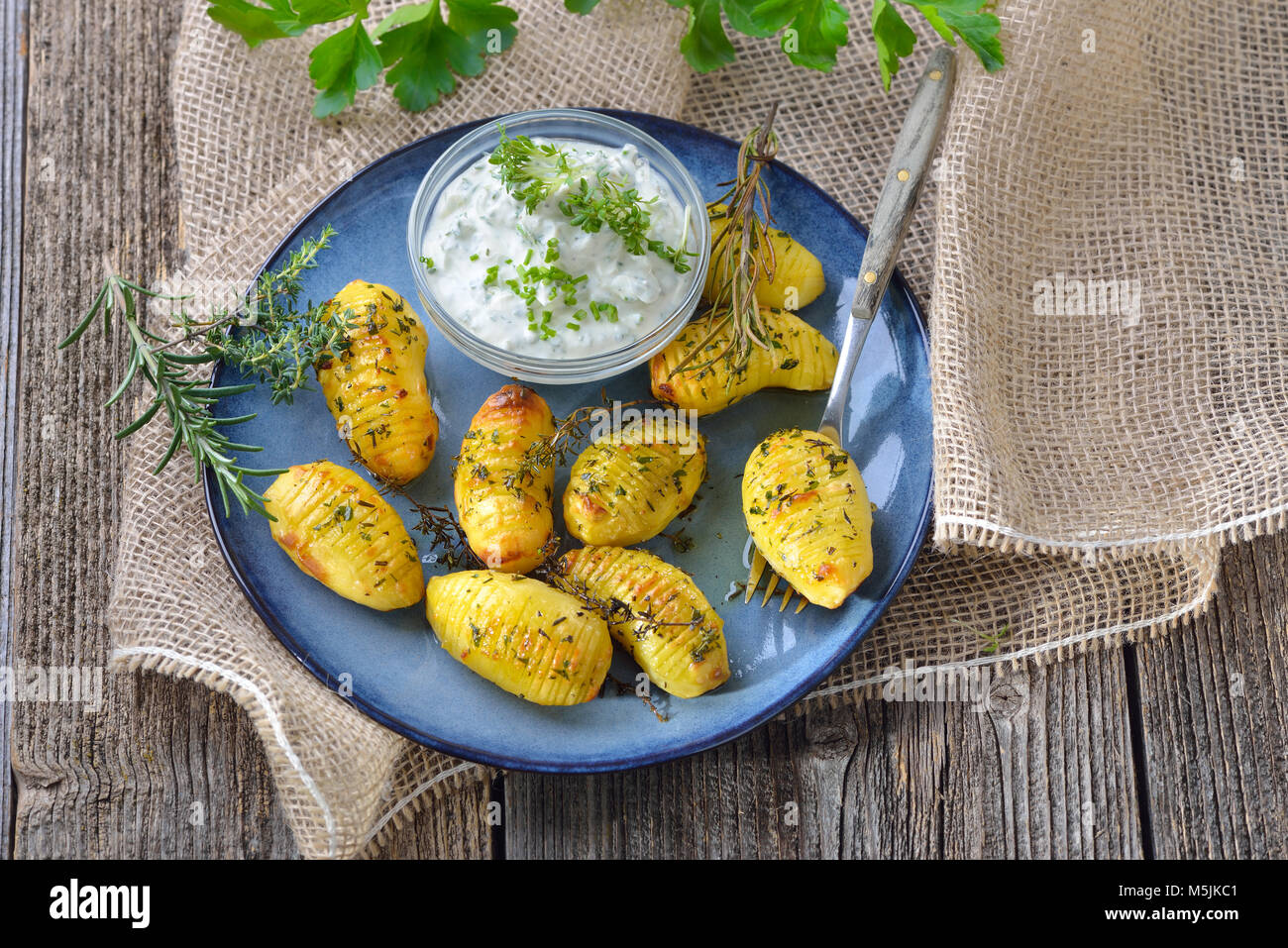 Vegetarian meal: Small potatoes baked with olive oil and served with fresh herb curd Stock Photo