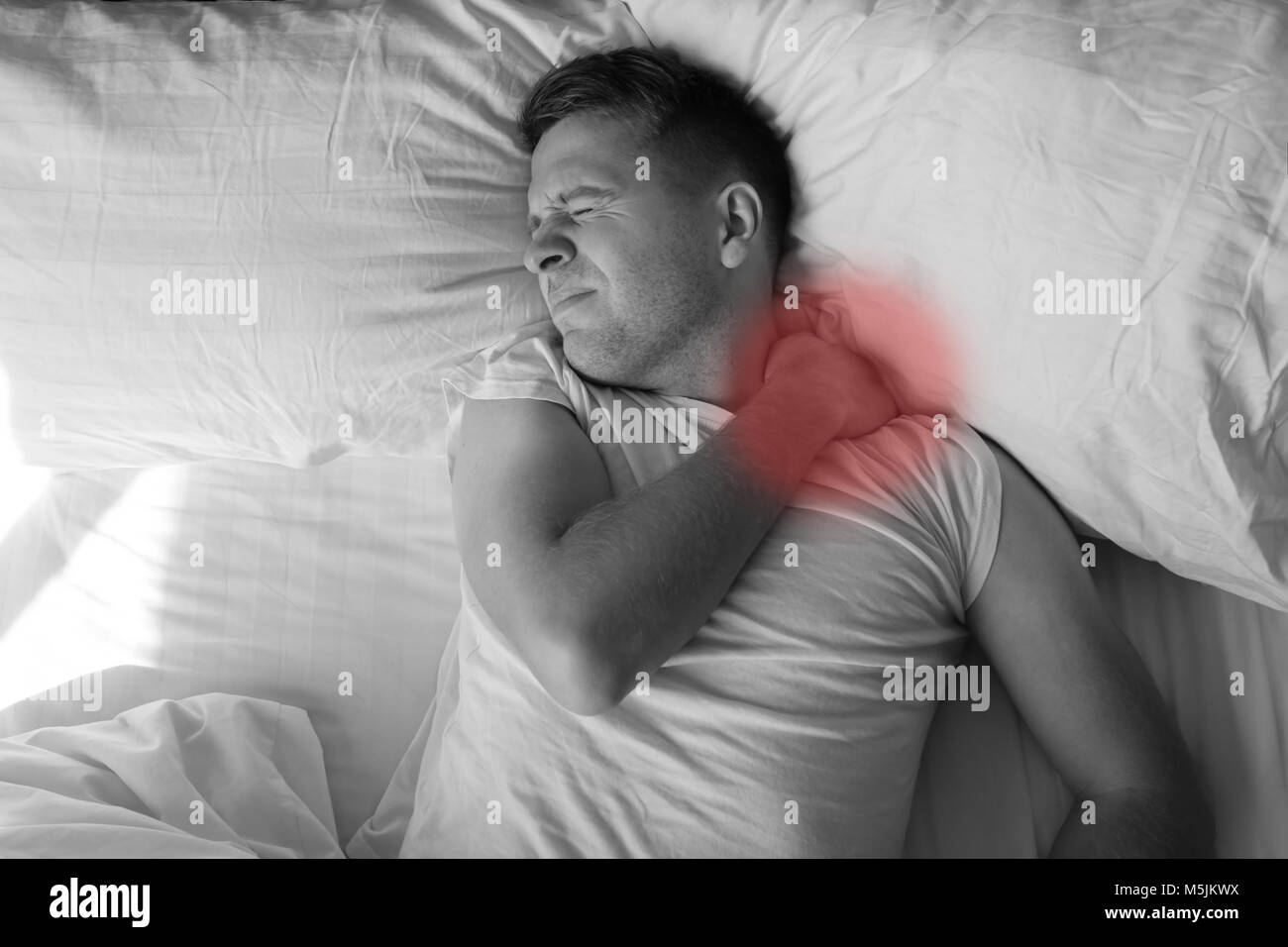 Caucasian young man having terrible pain in neck in bed in the morning Stock Photo Alamy