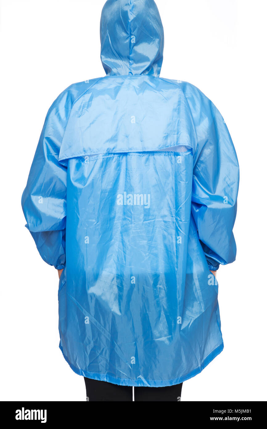Young woman is wearing blue raincoat with hood isolated on white