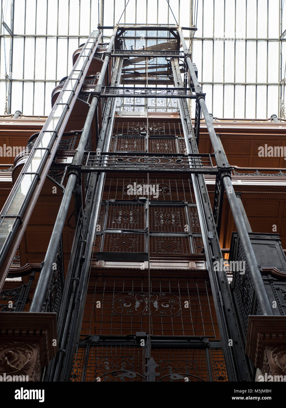 The wrought iron bird cage elevator in the lobby atrium of the Bradbury