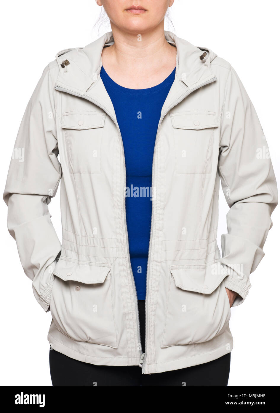 Young woman wearing beige rain jacket isolated on white background