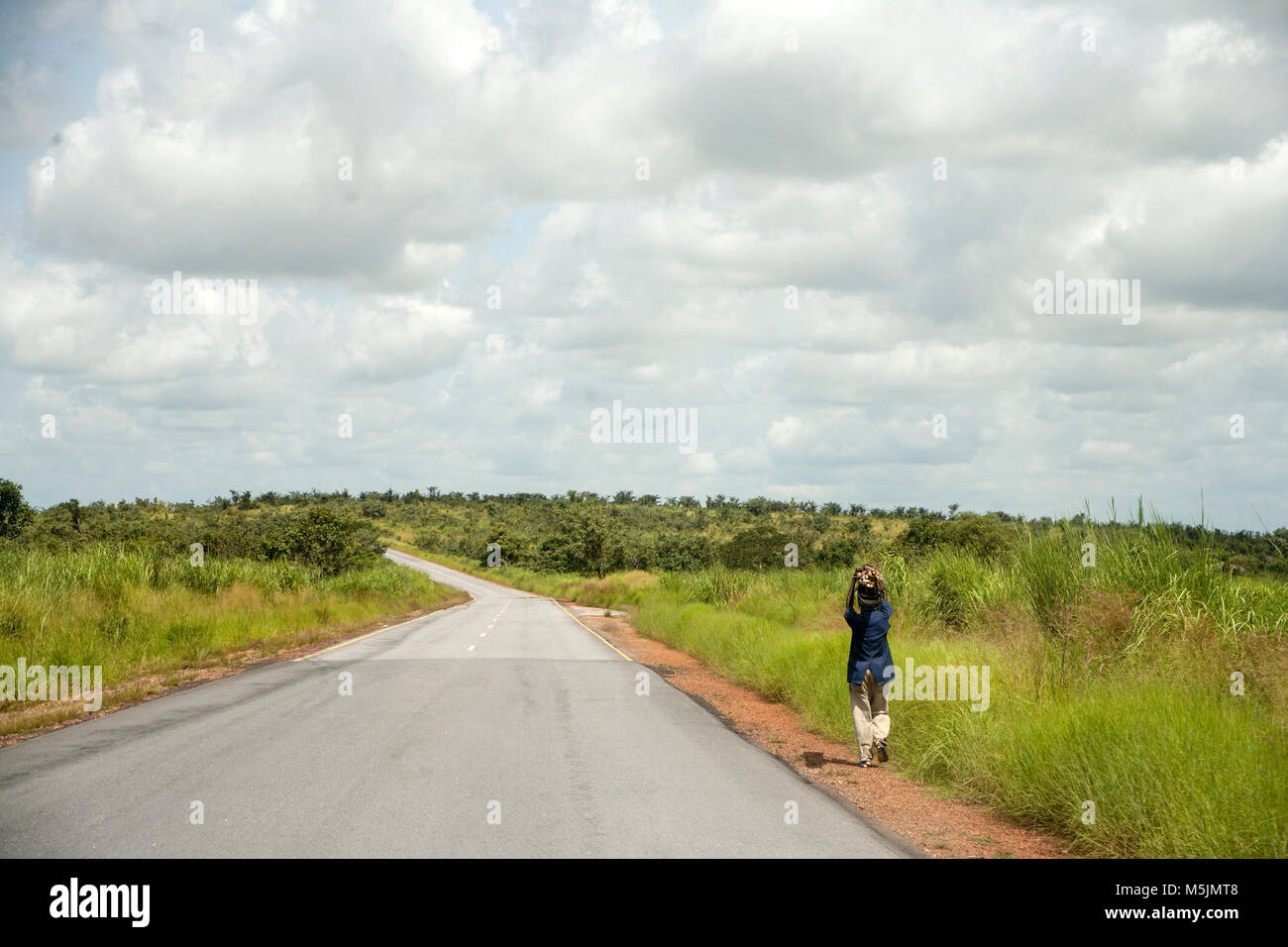 Person walking on the road between Freetown and Kono, Sierra Leone Stock Photo